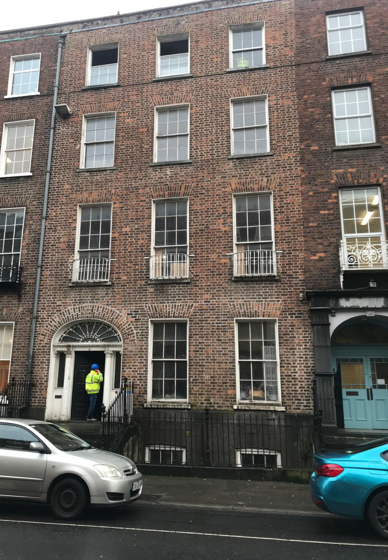 Weathered Georgian brick facade in Limerick, Ireland before restoration